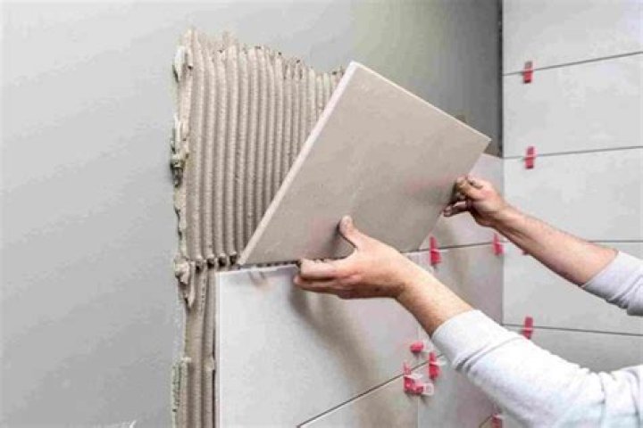 Do you put adhesive on tile or wall?