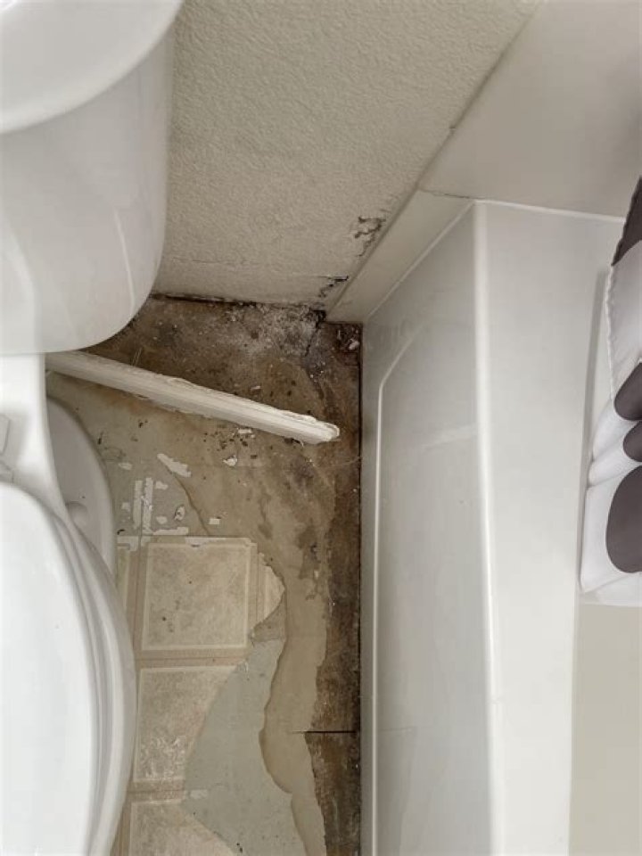 Why is there water under my bathroom tiles?